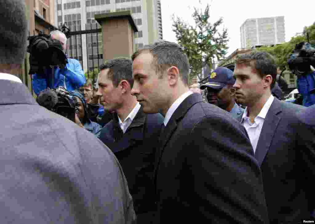 Oscar Pistorius arrives at court for the third day of his trial for the murder of his girlfriend Reeva Steenkamp at the North Gauteng High Court in Pretoria, March 5, 2014.