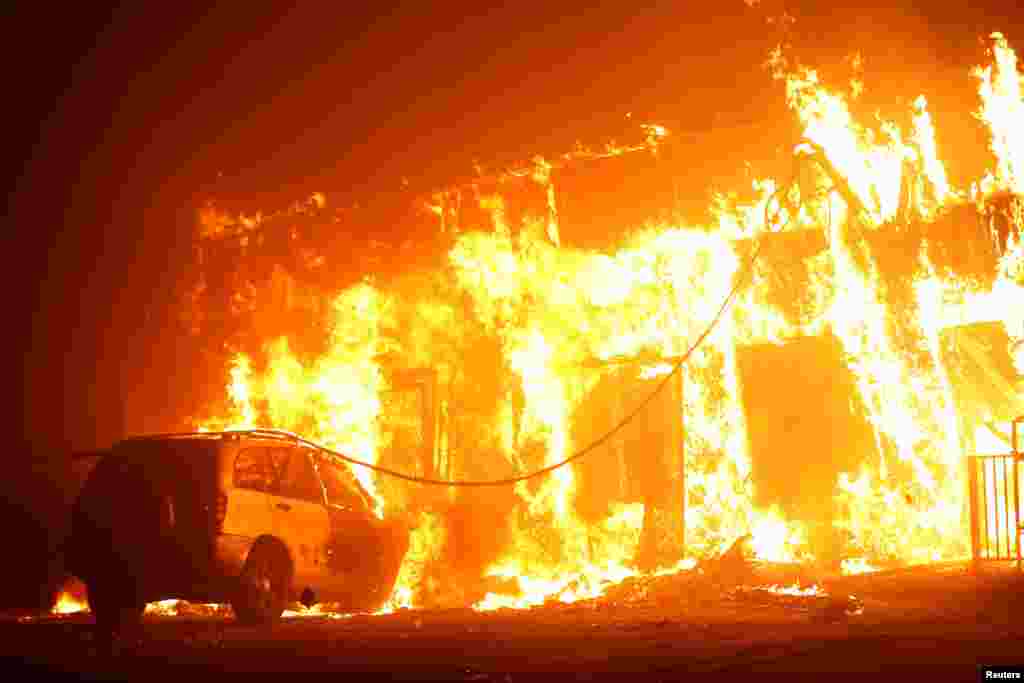 A structure is seen engulfed in flames during the Camp Fire in Paradise, California, U.S., Nov. 8, 2018. 