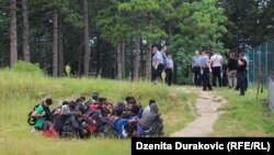 Bosnia and Herzegovina -- Police escorting migrants from temporary migrant camp Vucjak near Bihac, October 15, 2019.