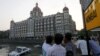 FILE - Tourists are seen in front of the Taj Mahal hotel, which was one of the targets of the Nov. 26, 2008 attacks, in Mumbai April 10, 2015. 
