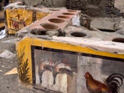 This image provided by the Pompeii Archeological park press office shows the thermopolium in the Pompeii archeological park, near Naples, Italy. @Luigi Spina (Courtesy)