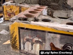 This image provided by the Pompeii Archeological park press office shows the thermopolium in the Pompeii archeological park, near Naples, Italy. @Luigi Spina (Courtesy)