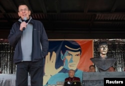 FILE - With a likeness of his Vulcan character, Mr. Spock, in the background, Leonard Nimoy speaks to the residents of the town of Vulcan, Alberta, April 23, 2010.