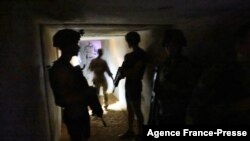 FILE - French soldiers of the Barkane operation seek protection in a shelter during a rocket attack at the Gao army base in Mali, Dec. 5, 2021. 