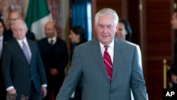 Secretary of State Rex Tillerson walks to his chair during the U.S.-Mexico bilateral meeting on disrupting transnational criminal organizations at State Department in Washington, Dec. 14, 2017.