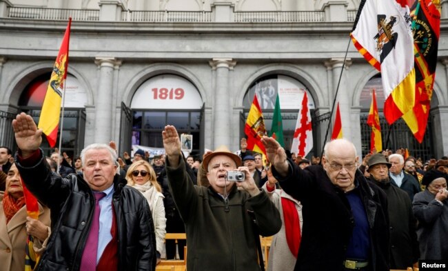 FILE - Supporters of Spain's late dictator Francisco Franco give fascist salutes during a gathering commemorating the anniversary of Franco's death at Madrid's Plaza de Oriente, Spain, Nov. 18, 2018.