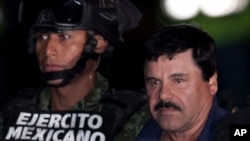 Mexican drug lord Joaquin "El Chapo" Guzman, right, is escorted by soldiers and marines to a waiting helicopter, at a federal hangar in Mexico City, Jan. 8, 2016. 