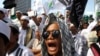 FILE - Members of the militant Islamic Defenders Front (FPI) shout slogan during a demontration in Jakarta, Indonesia.