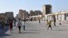 People walk along a street in Deir el Zour, Syria, in this photo provided by SANA, Sept. 11, 2017.