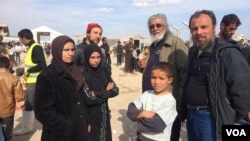 The family of Ammar Hazzin (3rd from L) says their flight from New Mosul was delayed after 21 people were executed by IS militants for attempting escape on March 26, 2017 in Hammam Alil, Iraq. (H.Murdock/VOA)