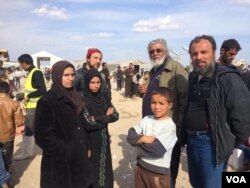 The family of Ammar Hazzin (3rd from L) says their flight from New Mosul was delayed after 21 people were executed by IS militants for attempting escape on March 26, 2017 in Hammam Alil, Iraq. (H.Murdock/VOA)