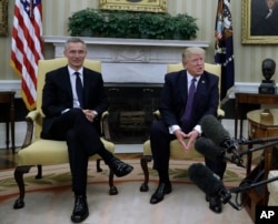 President Donald Trump (R) meets with NATO Secretary General Jens Stoltenberg in the Oval Office of the White House in Washington, April 12, 2017.