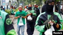 Pengemudi ojek online antre bantuan makanan gratis di tengah pandemi virus corona (COVID-19), di Jakarta, 17 April 2020. (Foto: Reuters)