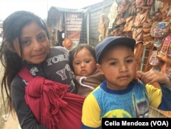 Children in Tzotzil community in the village of San Juan Chamula, Mexico, ask tourists to buy handicrafts, Feb. 15, 2016.