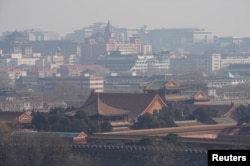 Forbidden City and other buildings are seen amid smog ahead of Chinese Lunar New Year in Beijing, Feb. 13, 2018.
