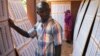 A man searches for his name on a list of eligible voters at an election center in Bamako, July 23, 2013.