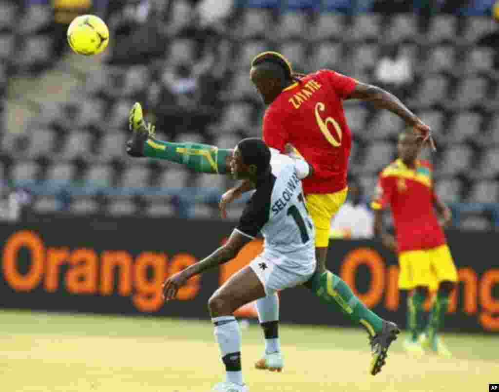 Guinea's Kamil Zayatte (6) challenges Botswana's Dipsy Selolwane during their African Nations Cup Group D soccer match Franceville Stadium January 28, 2012.