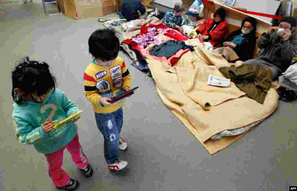 March 29: Children play with game consoles at an evacuation center in Koriayama, northern Japan. (Reuters/Kim Kyung-Hoon)
