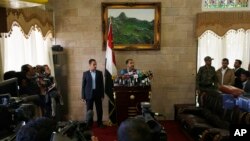 The spokesman of the Shi'ite rebels known as Houthis, Mohammed Abdel Salam, center, speaks at a press conference prior to the departure of the Houthi delegation for the Geneva peace talks, in Sana'a, Yemen, Dec. 12, 2015. 