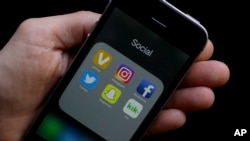 This June 16, 2017 photo shows social media app icons on a smartphone held by an Associated Press reporter in San Francisco. 