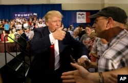 FILE - Republican presidential candidate Donald Trump greets supporters during a rally, Aug. 25, 2015, in Dubuque, Iowa.