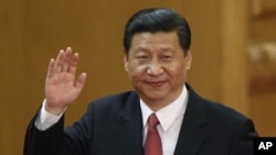 New Communist Party General Secretary Xi Jinping waves in Beijing's Great Hall of the People Nov. 15, 2012.