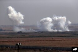 In this photo taken from the Turkish side of the border between Turkey and Syria, in Akcakale, Sanliurfa province, southeastern Turkey, smoke billows from targets inside Syria during bombardment by Turkish forces Thursday, Oct. 10, 2019.