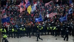 Police hold back supporters of US President Donald Trump as they gather outside the US Capitol's Rotunda on January 6, 2021, in Washington, DC. - Demonstrators breeched security and entered the Capitol as Congress debated the a 2020 presidential election