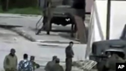 Image from amateur video made available by Shaam News Network Jan. 16, 2012, purports to show Syrian security forces in Hama, Syria. AP CANNOT INDEPENDENTLY VERIFY THE CONTENT, DATE, LOCATION OR AUTHENTICITY OF THIS MATERIAL.