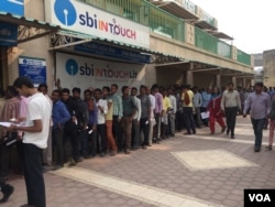 People wait in line to withdraw cash. (Photo: A. Pasricha)