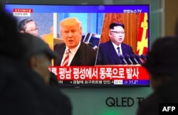 FILE - People watch a television news screen showing images of U.S. President Donald Trump and North Korean leader Kim Jong Un, at a railway station in Seoul, South Korea, Nov. 29, 2017.