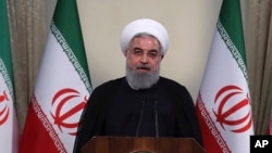 FILE - In this photo released by official website of the office of the Iranian Presidency, President Hassan Rouhani addresses the nation in a televised speech in Tehran, Iran, May 8, 2018. 