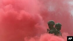 FILE - South Korean and U.S. Marines stand in a cloud of smoke during the 66th Incheon Landing Operations Commemoration ceremony in Incheon, South Korea, Sept. 9, 2016.