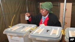 FILE - A woman casts her vote in presidential and parliamentary elections in Zimbabwe's capital, Harare, July, 31, 2013. Four women are among the presidential candidates seeking election on Monday.