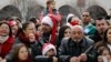 People attend Christmas celebrations outside the Church of the Nativity in the West Bank city of Bethlehem, Dec. 24, 2017. 