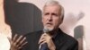 Film director James Cameron walks with his wife Suzy Amis on the red carpet during the opening ceremony of the second Beijing International Film Festival at the National Convention Center in Beijing, April 23, 2012.