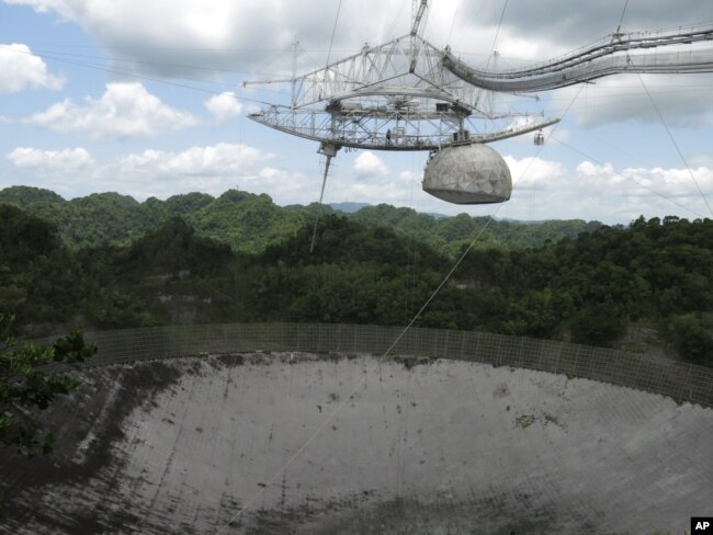 FILE - The world's largest single-dish radio telescope at the Arecibo Observatory in Arecibo, Puerto Rico, photographed July 13, 2016. Dwindling funds from the U.S. government and construction of bigger, more powerful telescopes are threatening this telescope's future.