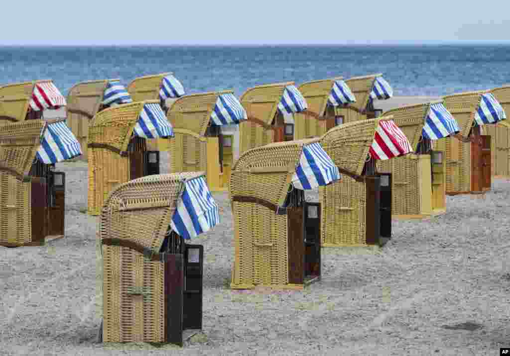 Empty beach chairs are placed on a beach near the Baltic Sea town of Travemuende, Germany.