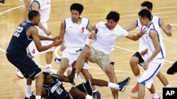 Players from American Georgetown University men's basketball team and China's Bayi men's basketball team fight during a friendly game at the Beijing Olympic Basketball Arena August 18, 2011