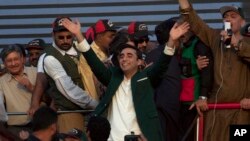 Bilawal Bhutto Zardari, center, chairman of Pakistan main opposition party 'Pakistan Peoples Party' waves to party supporters as he leave after addressing a rally in Karachi, Pakistan, Saturday, Oct. 18, 2014.