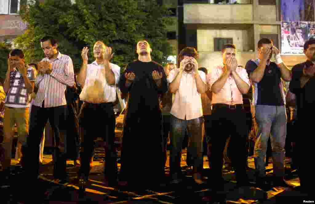 People perform Ramadan night prayers in Cairo, celebrating Lailat al-Qadr (the Night of Power), August 4, 2013. 
