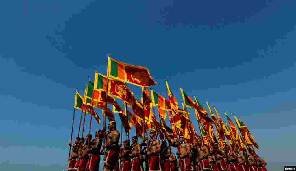 Sri Lanka's military members march with the national flags at the parade during a rehearsal for Sri Lanka's 70th Independence day celebrations in Colombo, Sri Lanka.