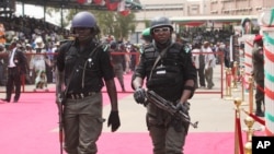 Nigerian police provide security during the ruling party's final campaign rally, at Eagle Square in Abuja, Nigeria, March 26, 2011. 