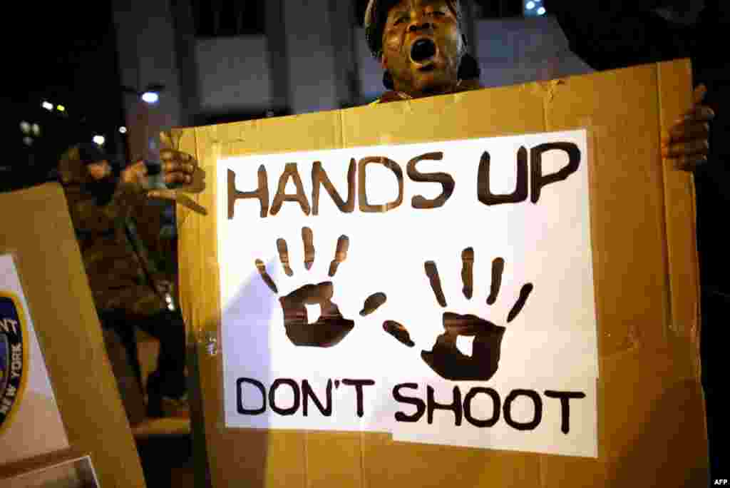 People gather in front of the Adam Clayton Powell Jr. State Office Buiding during a protest, Dec. 4, 2014 in New York.