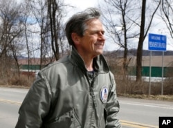 FILE - In this March 28, 2015 photo, Joe Sestak, a candidate seeking the Democratic Party nomination for the US Senate, passes a sign for the border between Pennsylvania and Ohio as he completes his "Walking In Other Pennsylvanian's Shoes," a walking tour across the state.