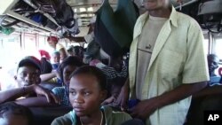 Port-au-Prince residents board a bus to leave the capital city for safer rural areas in Haiti