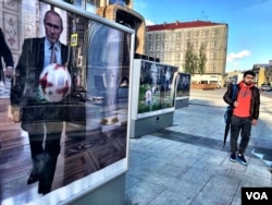 An image of Vladimir Putin playing soccer in the Kremlin adorns a downtown Moscow street. Securing mega-sporting events like the World Cup and the 2014 Winter Olympics have helped the Russian president craft his image as the leader of a country rising on