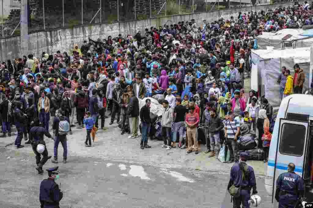 Refugees and migrants wait to be transfered from the island of Lesbos to the Greek main land.