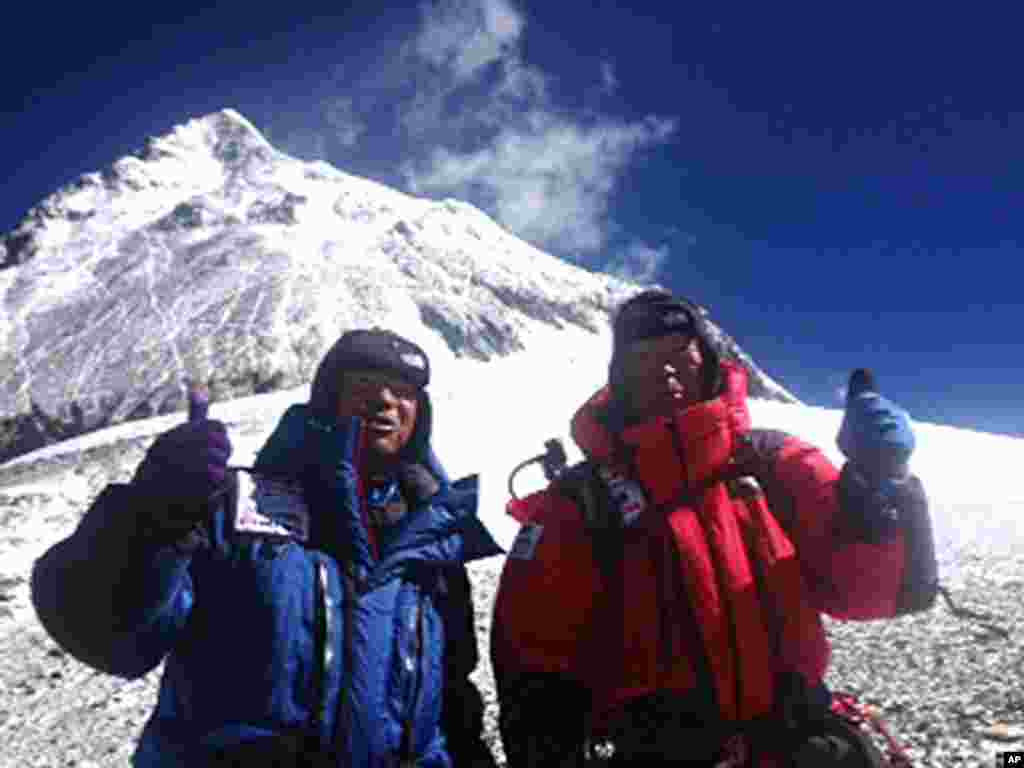 Yuichiro Miura, right, and his son, Gota pose at their South Col camp at 8,000 meters before their departure for Camp 5 during their attempt to scale the summit of Mount Everest, May 22, 2013. (AP Photo/Miura Dolphins Co. Ltd.) 