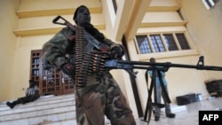 A Seleka coalition rebel stands guard on March 25, 2013 inside the presidential palace compound in Bangui.